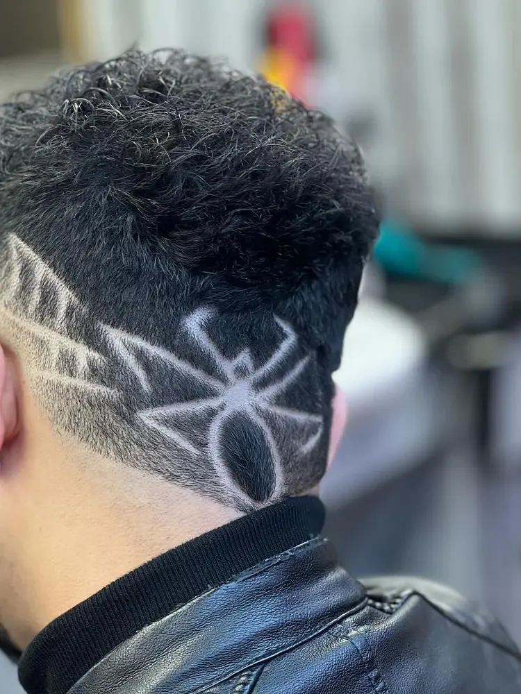 Spider pattern shaved into the back of a client's hair